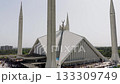 Aerial view of Faisal Mosque in Islamabad, Pakistan, showcasing its modern architecture and bustling plaza 133309749