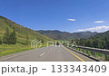 Scenic mountain highway journey, Serene drive through lush hills, Peaceful mountain road with scenic views, Tranquil travel scene along winding mountain highway Road, Chuisky tract, Altai 133343409