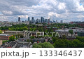 Panoramic view of Warsaw in summer with modern skyscrapers, green areas and cloudy sky. High-angle urban landscape of the Polish capital. 133346437