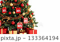 Christmas tree adorned with festive decorations and discount tags, showcasing vibrant ornaments and presents, camera pans to reveal details of holiday spirit 133364194