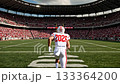 Football player in white uniform runs towards goalposts in stadium, crowd cheering, dynamic action sequence with camera following movement 133364200
