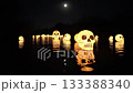 Eerie Lanterns Gracefully Floating on Water Beneath the Enchanting Glow of Moonlight 133388340