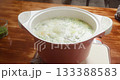 Woman cooking broccoli soup and adding chopped green onions, Female hands adding spring onions to boiling broccoli soup, Broccoli cream soup with vegetables boiling in pot. 133388583