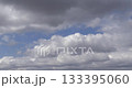 Time-lapse footage of white cumulus clouds in a blue sky. 133395060