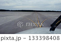 Cockpit view of airplane taxiing on runway with service vehicle ahead 133398408