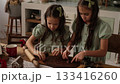 Girls make New Year's gingerbread cookies out of dough. Preparations for Christmas 133416260