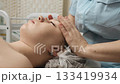 Cosmetologist facial massage with skincare cream in beauty clinic. 133419934