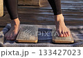 Bare Feet Stepping onto Sadhu Board of Nails 133427023