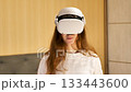 Woman Putting On and Using Virtual Reality Headset 133443600