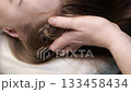 Scalp massage therapy in beauty clinic close up of hands and hair care. 133458434
