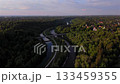 Cinematic aerial view of Burg Gruenwald, a medieval hilltop castle above the Isar valley in Gruenwald near Munich, Germany. Featuring the arch-shaped Gruenwalder Isarbruecke and canal in summer. 133459355