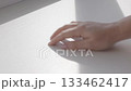 Hand wiping white surface with cloth, cleaning and hygiene concept 133462417