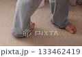 Top view of female bare feet on beige carpet, home comfort concept 133462419