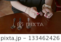 Woman hands arranging vintage spoons on wooden table, tableware display 133462426