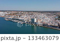 Aerial view drone shot of Ayamonte golden hour aerial view ayamonte marina with warm light on white buildings, quay and moored boats, waterfront cafes and terraces, reflections on Guadiana 133463079