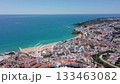 Aerial view of Albufeira and Praia dos Pescadores with turquoise Atlantic waters, sandy beach, and white coastal town architecture under clear sky. Concept of seaside tourism and Mediterranean charm 133463082