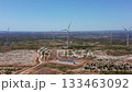 agricultural zones with wind generators, country environment showcasing turbine installations and access roads, renewable energy areas with farming facilities and transportation pathways 133463092