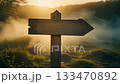A quiet journey guided by wooden signposts shrouded in morning mist 133470892