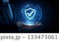 dark background with businessman open palm, hovering 3D shield and globe grid 133473061