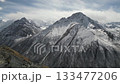Majestic mountain landscape with snow-capped peaks, camera pans right 133477206