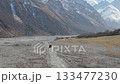 Vehicle traverses rocky terrain, camera follows with a smooth dolly motion 133477230