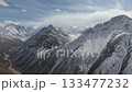 Majestic mountain range with snow-capped peaks, camera pans across landscape 133477232
