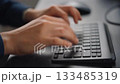 Seamless loop video of hands typing on a keyboard (close-up of hands) 133485319