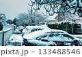 Fresh snow covering cars, trees, and a quiet residential street in Seyssins near Grenoble, showing rare early-winter weather conditions in November, France 133488546