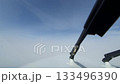 POV pilot view as aircraft breaks through white cloud from overcast iino bright light 133496390