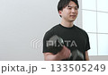 A man in his 20s doing muscle training with dumbbells A man in his 20s doing muscle training with dumbbells 133505249
