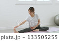 Young woman receiving training from a personal trainer Young woman receiving training from a personal trainer 133505255