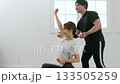 Young woman receiving training from a personal trainer Young woman receiving training from a personal trainer 133505259