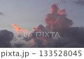 Colorful clouds at sunset with shades of pink and gray. The sky is partially cloudy, creating a serene atmosphere. 133528045