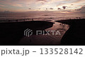 Drone shot of sunset in Bali. The river flows into the Pacific Ocean. People are having fun and having a nice time 133528142