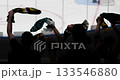 Cheering crowd silhouettes celebrate a victory at an ice hockey game. 133546880