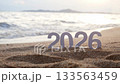 number 2026 for new year sign on summer beach at sunset time, with ripple sea wave and beautiful nature at background, 2026 New Year celebration concept 133563459