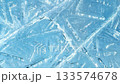 Texture footage of white cracks and bubbles spreading on the surface of blue ice [Generative AI] 133574678