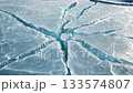 Texture footage of radial cracks spreading on the surface of blue ice [Generative AI] 133574807
