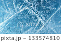 Texture footage of white cracks and bubbles spreading on the surface of blue ice [Generative AI] 133574810