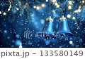 Festive blue christmas bells hanging on a fir tree branch with glowing lights, swinging gently as snowflakes fall against a magical, dark, shimmering background with beautiful bokeh effect 133580149