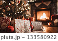 Festive greeting cards and wrapped presents resting on a wooden table with a decorated christmas tree and a warm, burning fireplace in the background, creating a peaceful and magical holiday scene 133580922