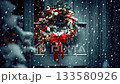 Snow falling gently on a festive christmas wreath with a red bow, hanging on a dark wooden door at night, creating a magical and cozy holiday atmosphere with festive lights in the background 133580926