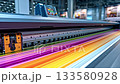 Industrial large format inkjet printer moving its print head while producing a vibrant, multi colored graphic on paper, showcasing modern digital printing technology in a professional workshop 133580928