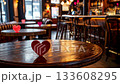 Bar or restaurant featuring wooden tables adorned with red and pink heart decorations, creating a romantic and festive ambiance perfect for valentine's day dating and celebrating love 133608295