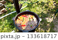 Pilaf recipe outdoors in a cast iron cauldron bubbling zirvak rice and carrots top view camera moves up clip for food blogs how to videos and spice brands 133618717