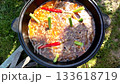 Pilaf recipe outdoors in a cast iron cauldron bubbling zirvak rice and carrots top view camera moves up clip for food blogs how to videos and spice brands 133618719