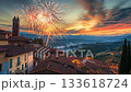 New Year's Eve fireworks illuminate rustic village with terracotta rooftops and olive-hued walls 133618724