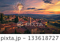 Fireworks on New Year's Eve over a rustic village with terracotta rooftops and olive-colored walls 133618727