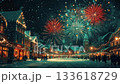 Classic New Year's Eve fireworks light up a snow-covered town square in rich red and green 133618729