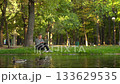Young man working on laptop in riverside park, 4K 133629535